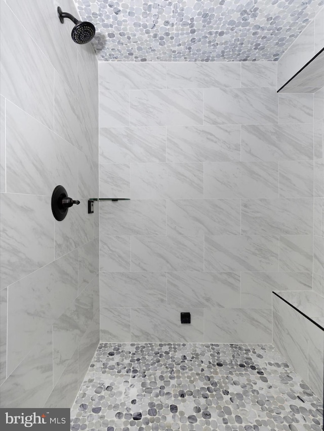 bathroom with tiled shower