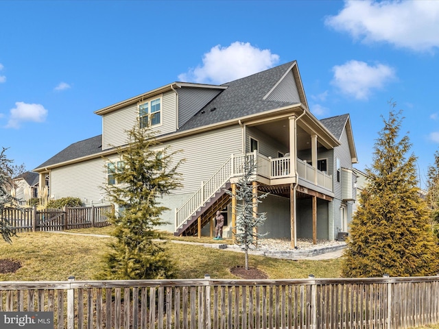 rear view of house with a yard and a deck