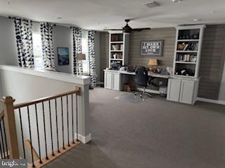 home office featuring carpet floors, built in desk, and ceiling fan