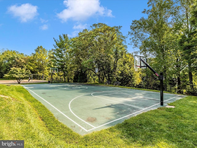 view of basketball court with a lawn