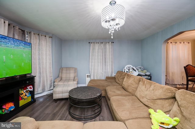 living room featuring wood-type flooring, radiator, and a chandelier