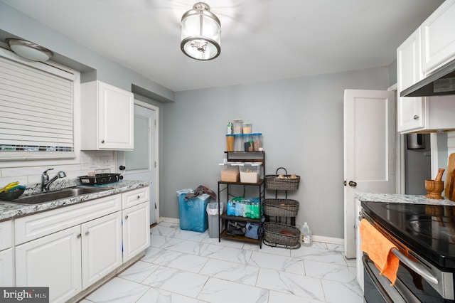 kitchen with white cabinetry, tasteful backsplash, electric range, and sink