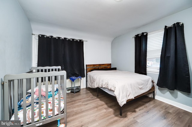 bedroom with wood-type flooring