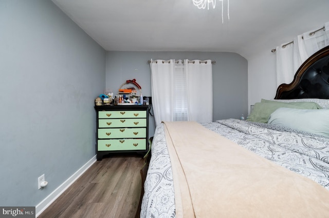 bedroom with dark wood-type flooring