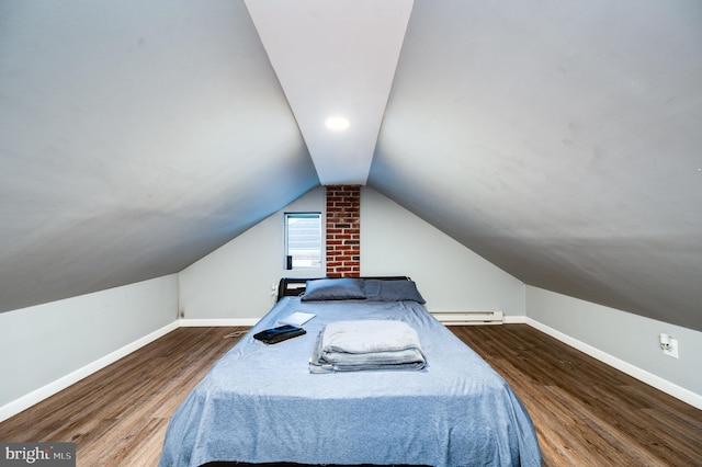 bedroom featuring baseboard heating, vaulted ceiling, and hardwood / wood-style floors