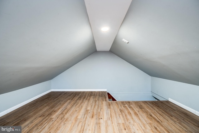 bonus room featuring lofted ceiling and wood-type flooring