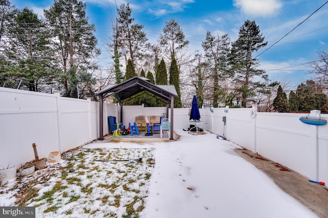 yard layered in snow featuring a gazebo