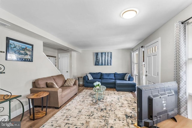 living room featuring heating unit and hardwood / wood-style floors