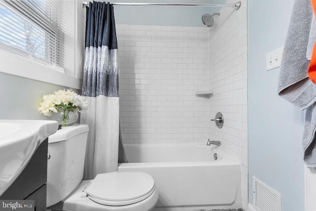 full bathroom featuring toilet, shower / bath combination with curtain, and vanity