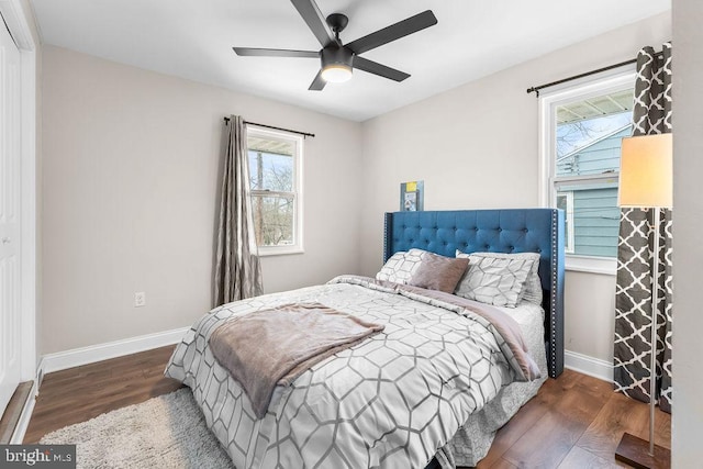 bedroom with ceiling fan and dark wood-type flooring