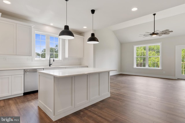 kitchen with sink, white cabinets, stainless steel dishwasher, and a center island