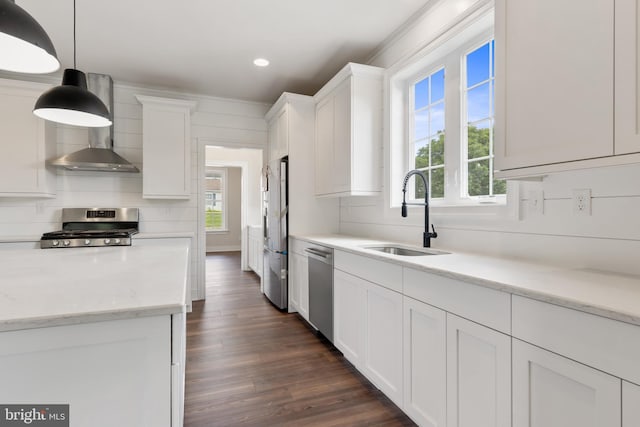 kitchen with white cabinetry, appliances with stainless steel finishes, plenty of natural light, decorative light fixtures, and sink