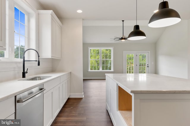 kitchen with ceiling fan, decorative light fixtures, stainless steel dishwasher, white cabinets, and sink