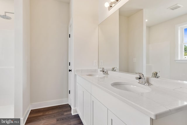 bathroom with vanity and hardwood / wood-style flooring