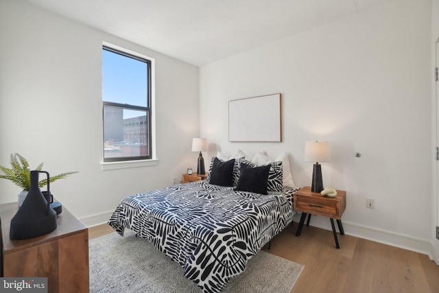 bedroom featuring light hardwood / wood-style floors and multiple windows