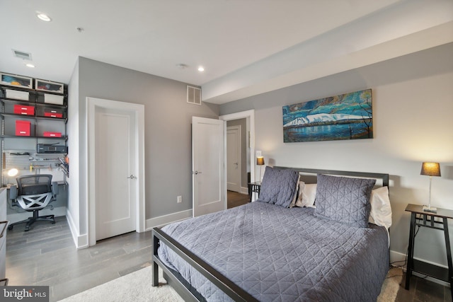 bedroom with hardwood / wood-style flooring