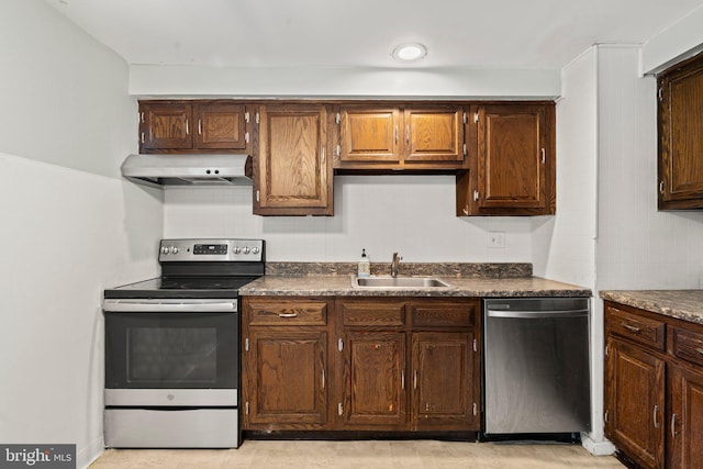 kitchen featuring stainless steel appliances, extractor fan, and sink