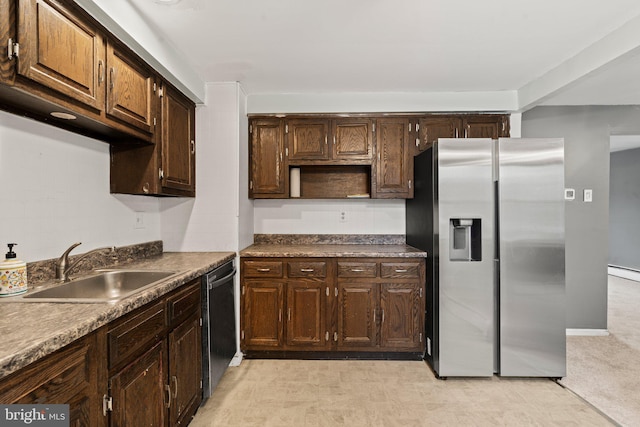 kitchen featuring a baseboard radiator, dark brown cabinetry, appliances with stainless steel finishes, light carpet, and sink