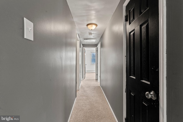 hall with light colored carpet