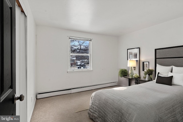 carpeted bedroom featuring baseboard heating