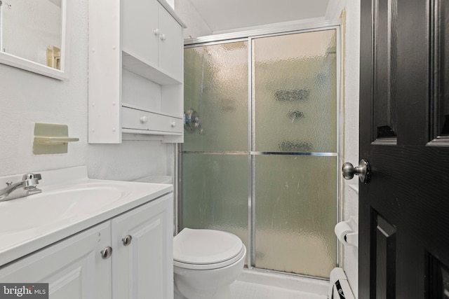 bathroom featuring baseboard heating, toilet, vanity, and walk in shower