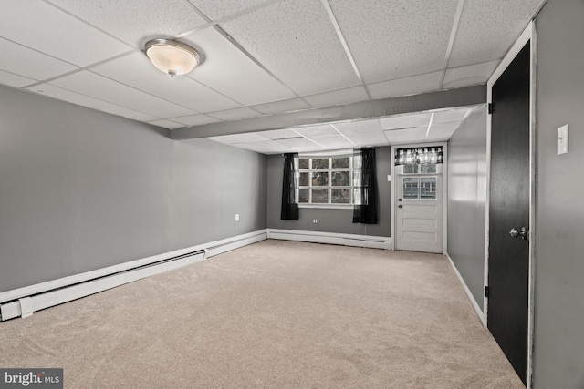 basement with carpet flooring and a drop ceiling