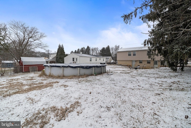 yard layered in snow featuring a covered pool