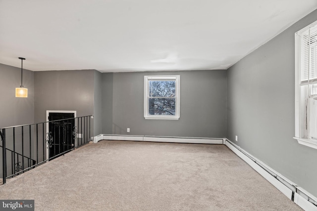 spare room featuring carpet floors and baseboard heating