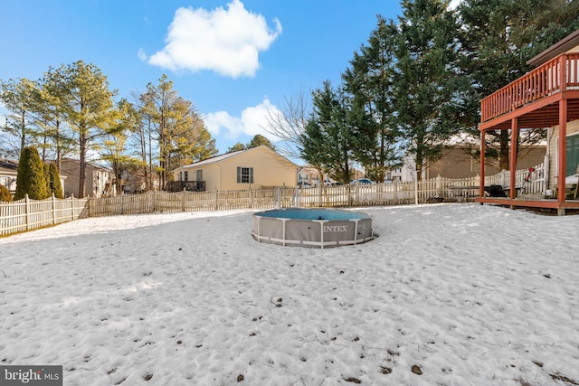 snowy yard featuring a swimming pool side deck