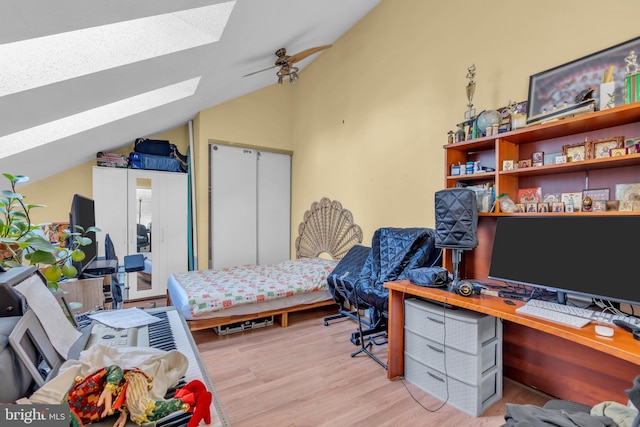 bedroom featuring lofted ceiling and light wood-type flooring