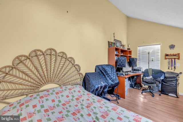 bedroom featuring wood-type flooring and vaulted ceiling