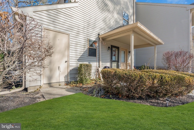 doorway to property with a yard