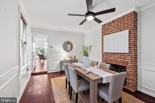 dining room with crown molding, ceiling fan, and dark hardwood / wood-style flooring