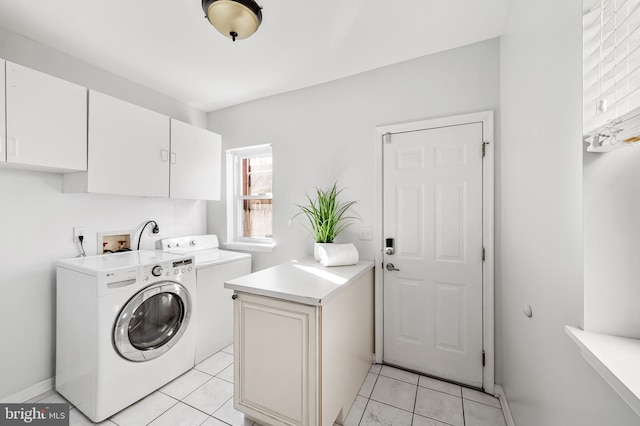 laundry area with cabinets, independent washer and dryer, and light tile patterned floors