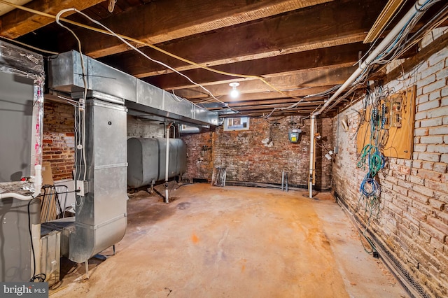 basement featuring brick wall