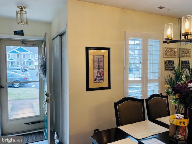 dining area featuring plenty of natural light and a notable chandelier