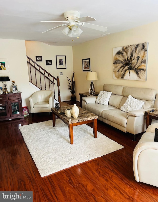 living room with ceiling fan and dark hardwood / wood-style flooring