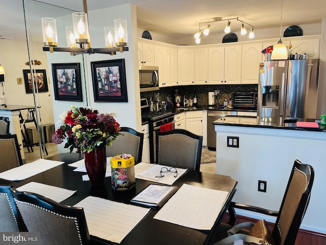 dining area with an inviting chandelier