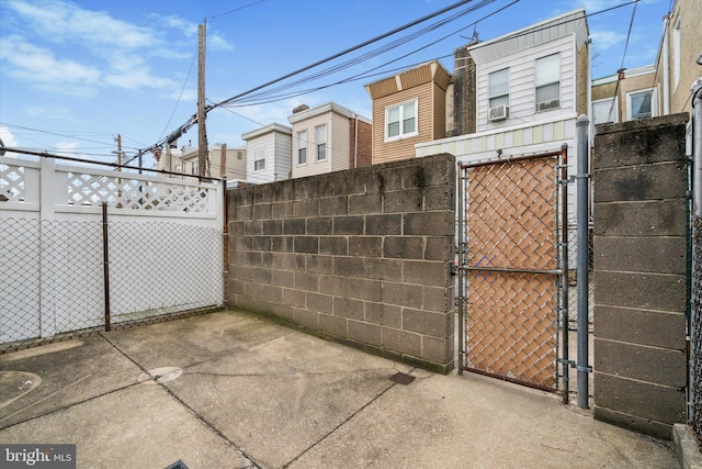 view of gate with a patio