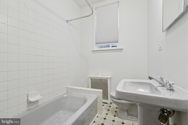 bathroom featuring shower / washtub combination and radiator heating unit