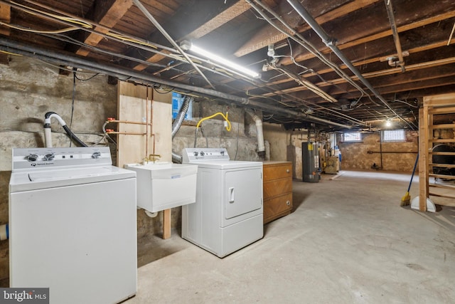 basement with separate washer and dryer, sink, and water heater