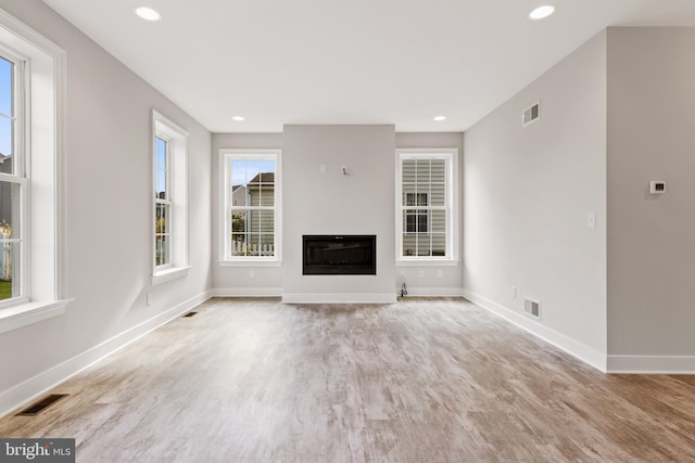 unfurnished living room featuring light hardwood / wood-style flooring