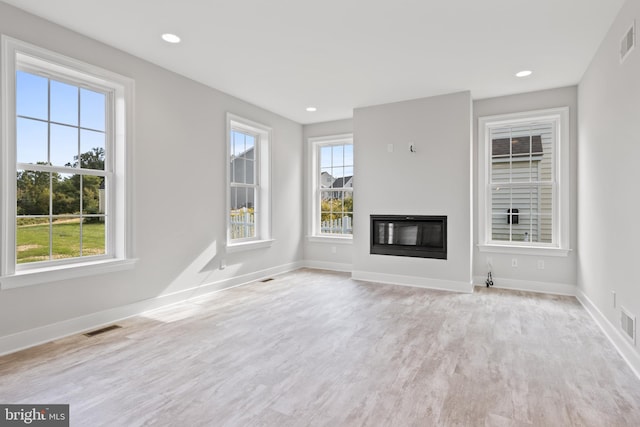 unfurnished living room with light hardwood / wood-style flooring