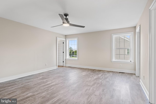 spare room featuring light hardwood / wood-style floors and ceiling fan