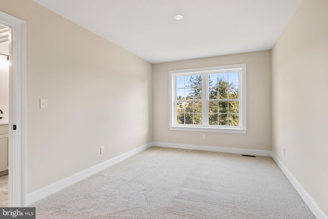 empty room featuring light carpet