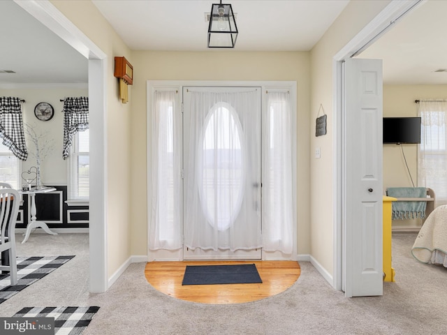 view of carpeted foyer entrance