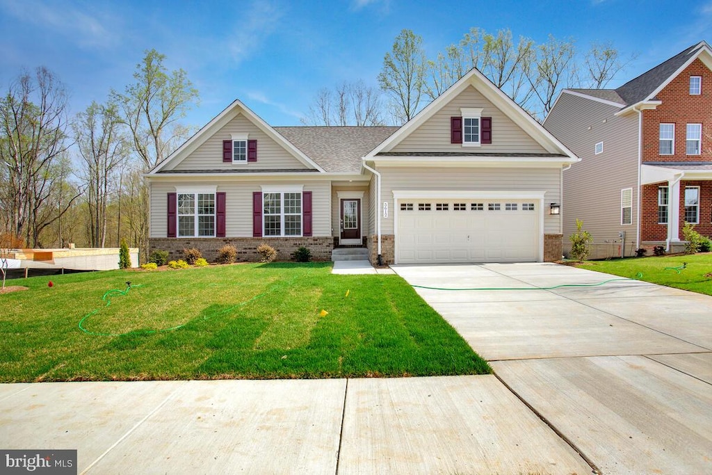 craftsman inspired home with a garage and a front lawn