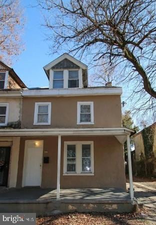 rear view of house featuring a porch