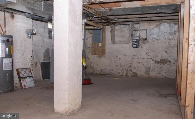 basement featuring water heater and electric panel