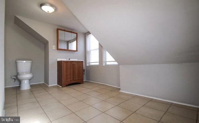 bonus room featuring vaulted ceiling and light tile patterned flooring